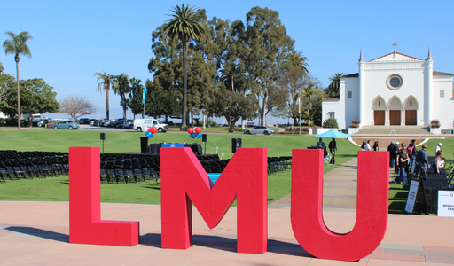Students at admitted lions days, photo is focused on big LMU Letters that sit at the event for photoshoots.